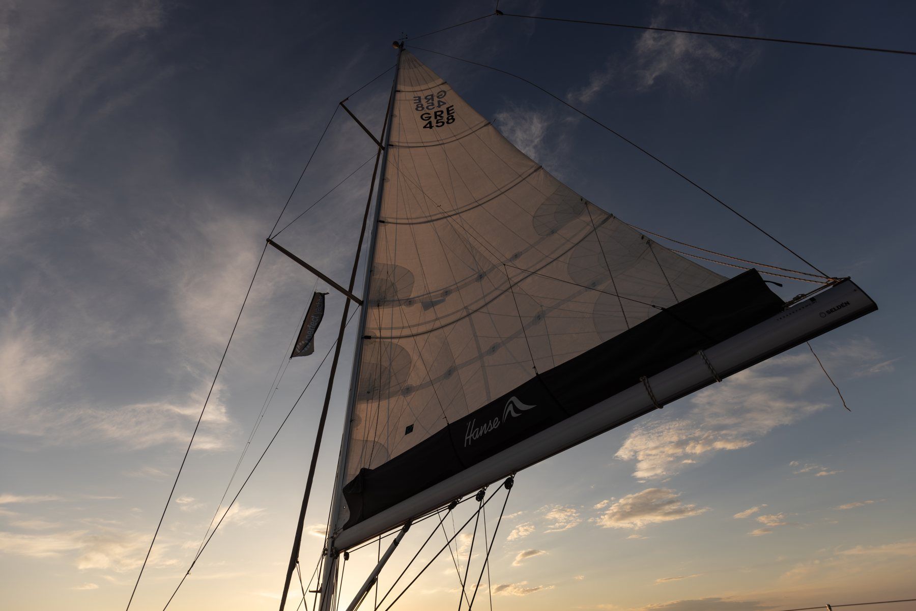 A sail against a dramatic evening sky